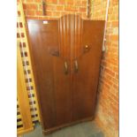 An oak effect two door fitted wardrobe, in the Deco style, with raised floral scrolls.