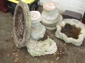Two reconstituted stone birdbaths and a cherub seated.
