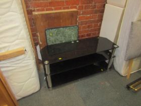A collapsible wallpaper pasting table, side table, and a black glass three tier television