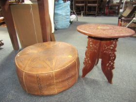 An Eastern circular side table, on a collapsible three fold base, and a footstool. (2) The