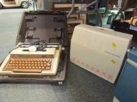 A Smiths Corona cased typewriter, and a Frister and Rossman cased sewing machine. (2)