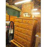 A pine chest of two short and four long drawers, pine dressing table with three drawers, and a