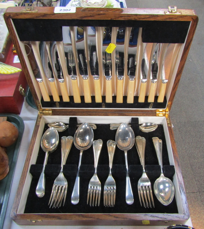 A cased canteen of silver plated and bone handled cutlery, in oak case.