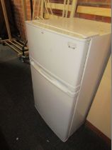 A white under counter fridge freezer.