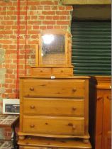 A pine three drawer chest, with a pine two drawer dressing table mirror. (2)