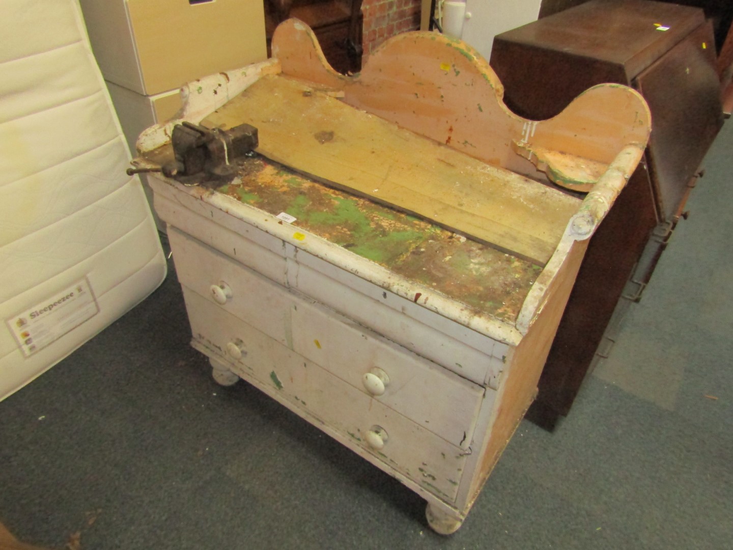 A 19thC painted pine wash stand, the arched and raised top converted to a work bench, above