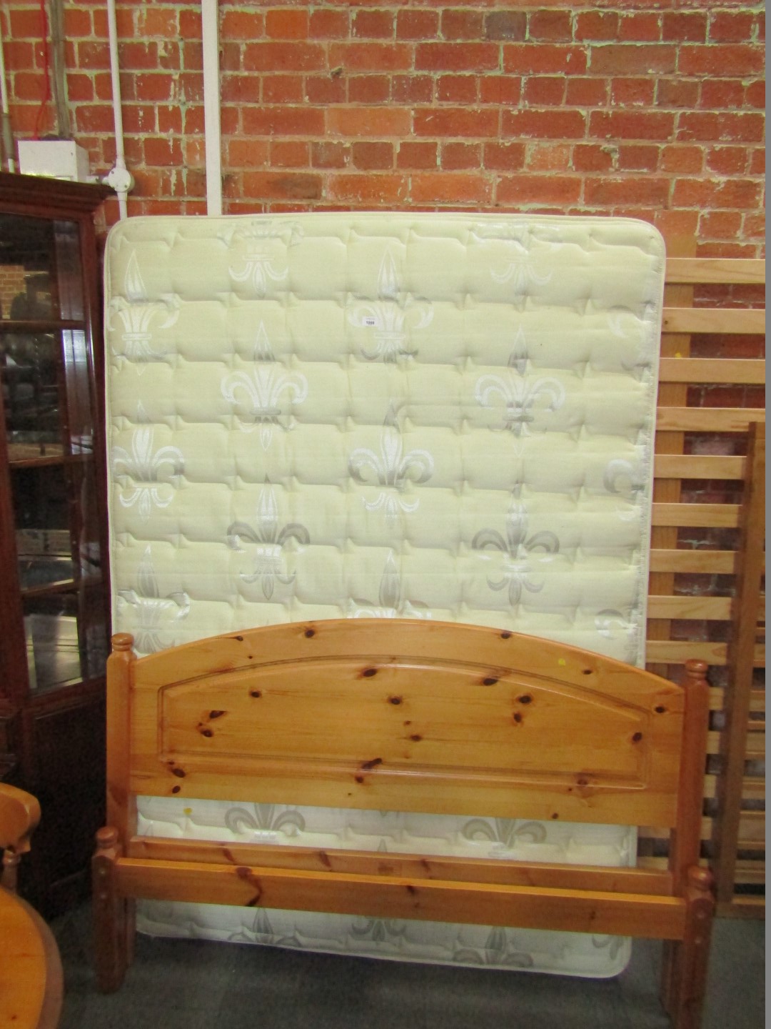 A pine double bed, frame and mattress.