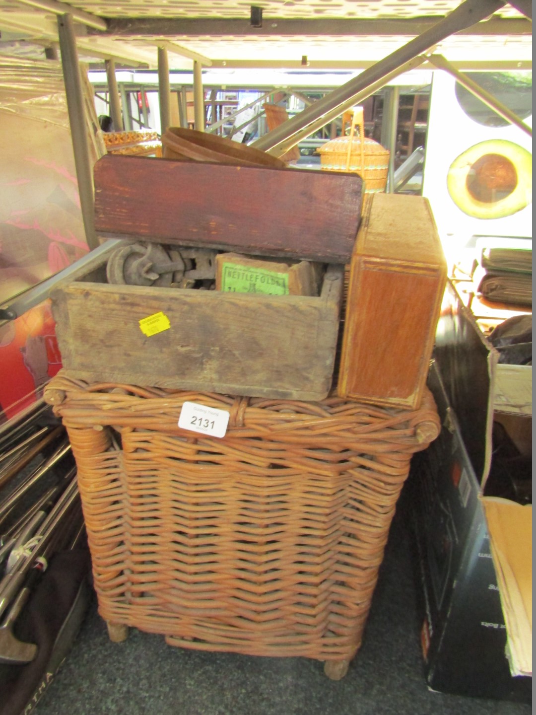 A wicker basket and contents, of furniture parts, handles, drills, etc. (a quantity)