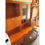A teak finish bookcase, two sectional ottoman, two drop leaf tables, two dining chairs, and four