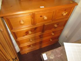 A pine chest of drawers, with arrangement of three and two short drawers and two long drawers.