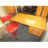 An office desk and red Club 8 office chair.