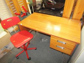 An office desk and red Club 8 office chair.