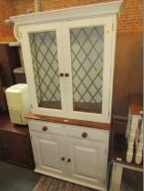 A painted pine dresser, white painted frame with astragal glazed doors above arrangement of two