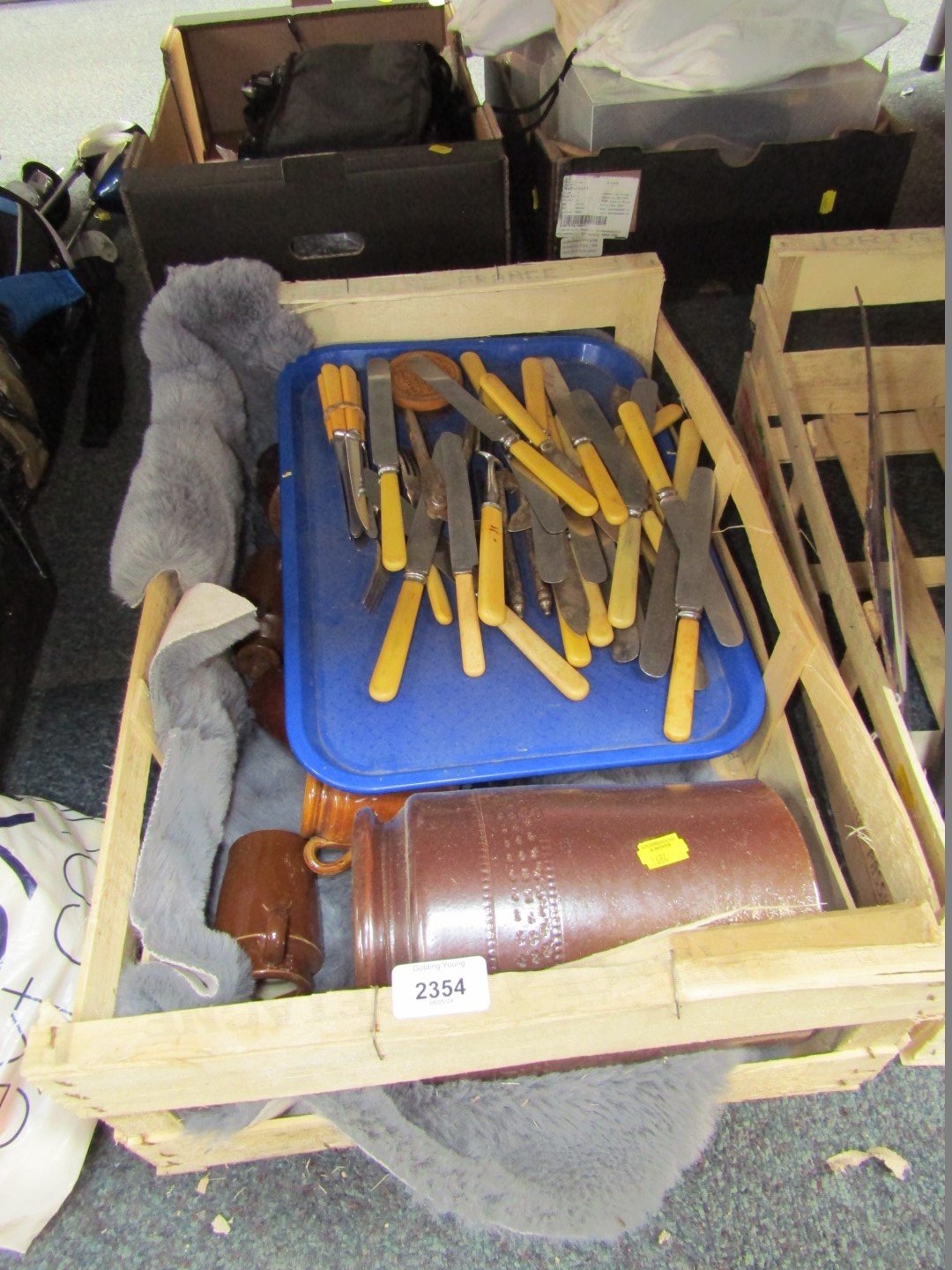 Various stoneware bottles and bone handled cutlery.