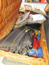 A wicker basket and contents, Scalextric, and a small group of records.