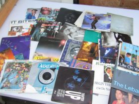 A group of vinyl singles, including Iron Maiden Flight of Icarus, Iron Maiden A Stranger in