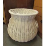 A wicker laundry basket with lid.