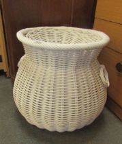 A wicker laundry basket with lid.