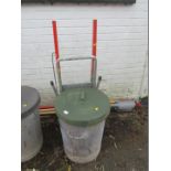 A galvanised bin, with rubber lid, and a Beldray step ladder.