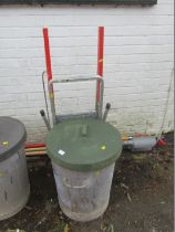 A galvanised bin, with rubber lid, and a Beldray step ladder.