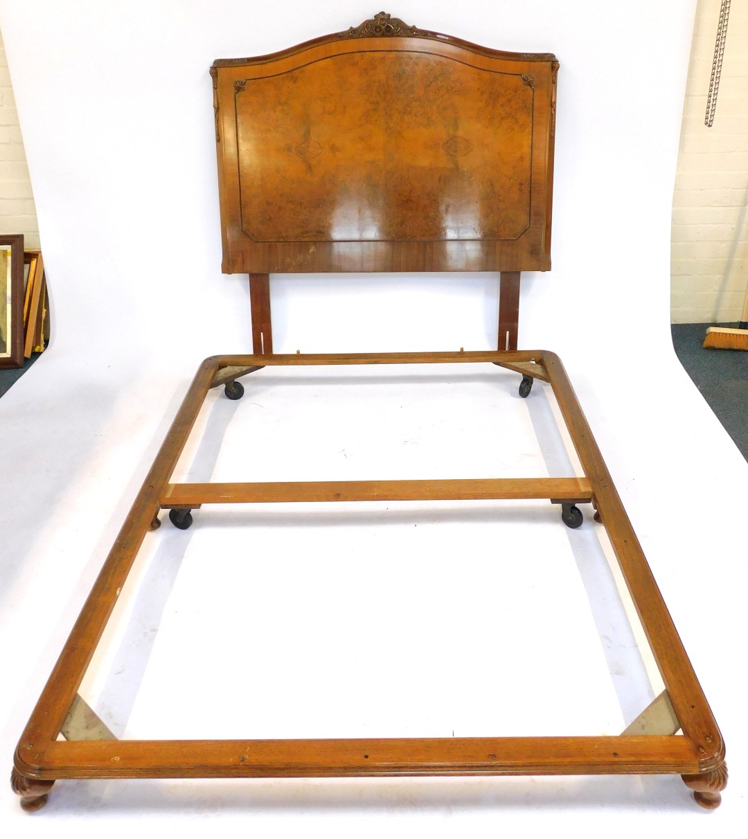 An early 20thC walnut double bed, the headboard with floral and foliate carved crest rail, the - Image 2 of 2