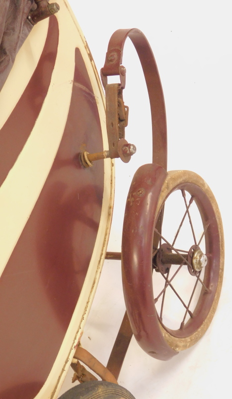 A vintage doll's pram, steel framed with cream and brown painted decoration, and a painted papier - Image 4 of 5
