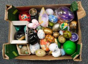 A collection of painted eggs, ceramic and wooden, comprising some Eastern examples, painted
