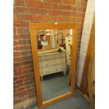 A glass tabletop, and a pine framed rectangular wall mirror, the mirror 139cm x 76cm.