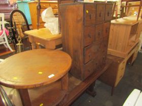 An Eastern inspired storage rack, with an arrangement of twelve drawers, and a circular oak low side