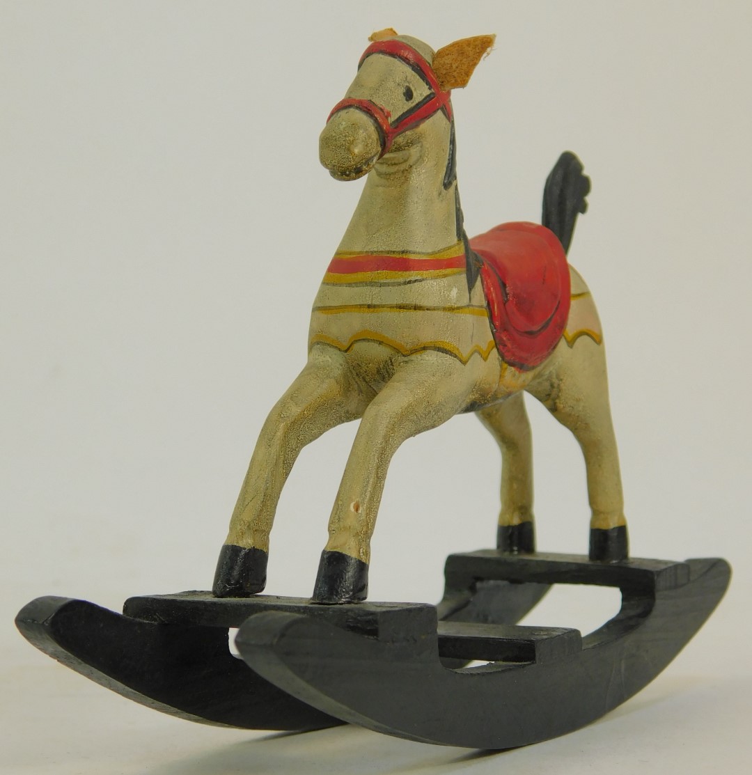 A miniature rocking horse, with red seat on painted white horse, 9cm high. - Image 3 of 3