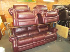 A Laz-y-Boy maroon leather sofa suite, comprising a three seater manual reclining sofa, an