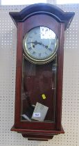 A Lincoln mahogany cased drop dial wall clock, with a white finish Roman numeric dial, thirty one