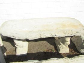 A reconstituted stone garden bench, on two squirrel supports, 43cm high, 99cm wide, 37cm deep.