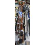 A group of walking sticks, each with souvenir crests.