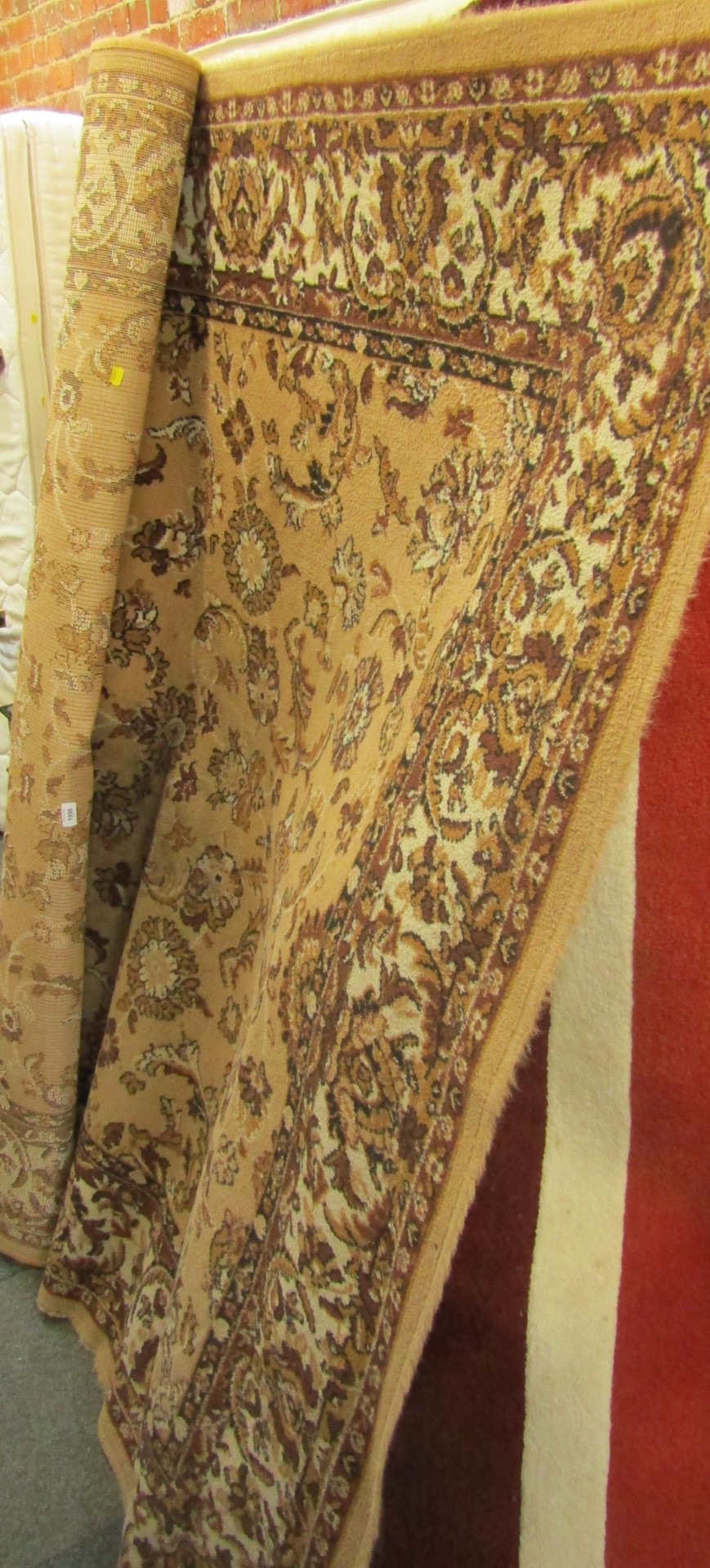 A brown floral patterned wool cut rug.