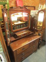 An Edwardian mahogany dressing table, the arch frame mirror with two central drawers above two short