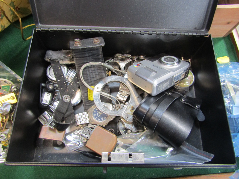 A metal cash box and contents, to include Accurist and other wristwatches, Kodak camera, lighters,