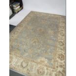 A Moldabela machine woven rug, 200cm x 300cm, on blue and cream ground.