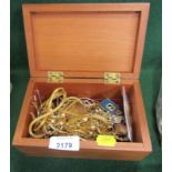 A wooden jewellery box and contents, of swallow brooches, dress rings, gold coloured necklaces,