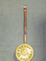 A 19thC copper warming pan, with pierced decoration, on turned wooden handle.