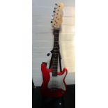 A red electric guitar, with Nevada decal, on stand.