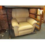A cream leather reclining single armchair.