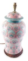 A late Chinese porcelain lamp base, decorated with a design of peacocks on a pink ground, 56cm high.