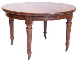 An early 20thC mahogany extending dining table, with rounded ends, moulded edge and a plain frieze,
