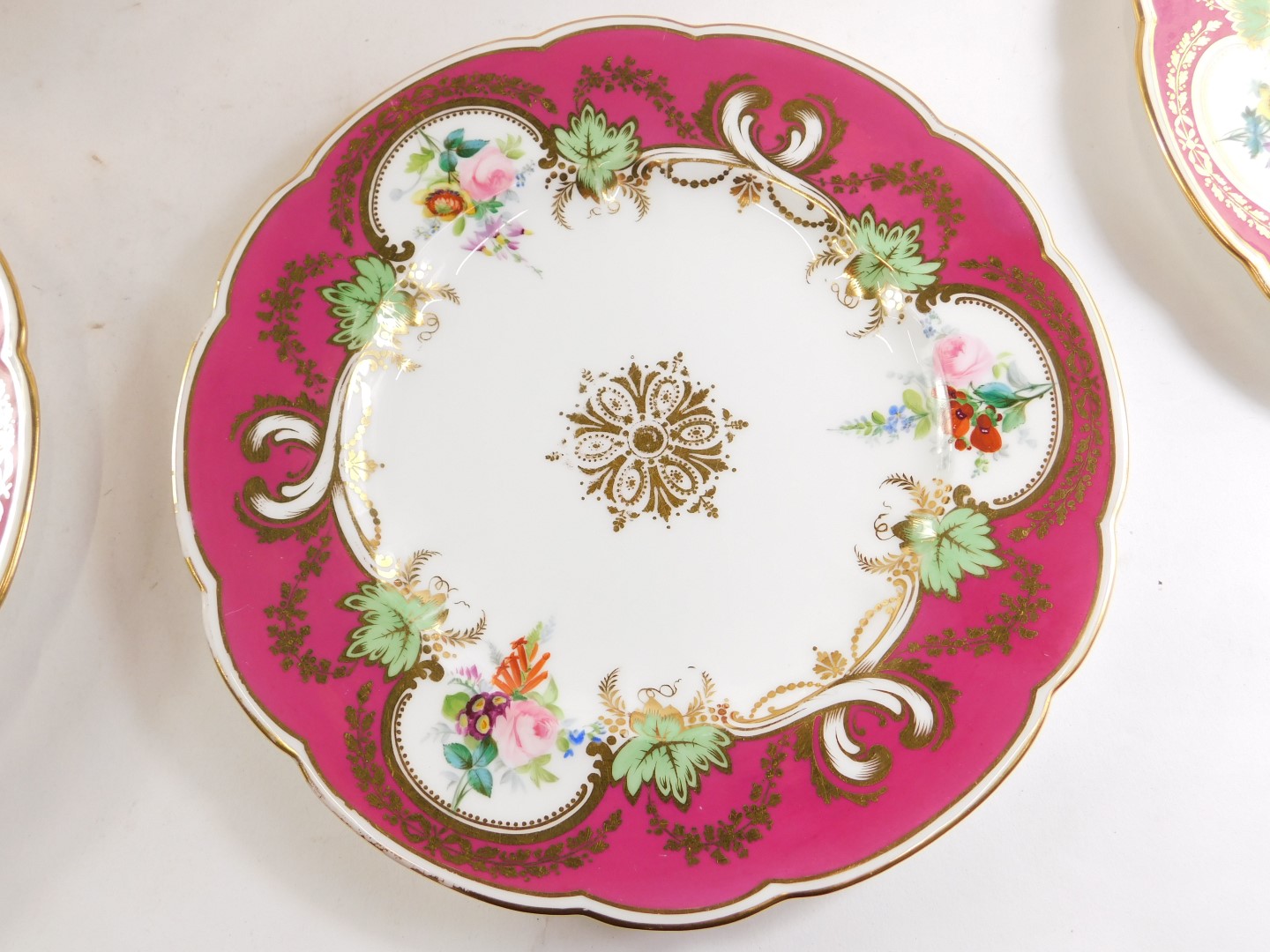 A 19thC porcelain dessert service, with puce border, painted with flower sprays, picked out in gilt, - Image 3 of 3
