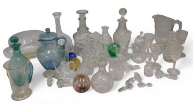 A quantity of 19thC and later glass, to include decanters, coloured glass floats, stoppers, jugs, et