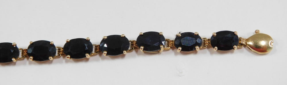 A sapphire set line bracelet, with oval sapphires, in claw mount, on yellow metal bracelet stamped 1 - Image 3 of 4