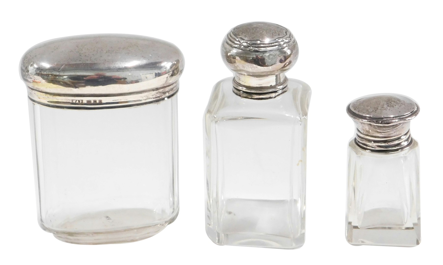 Two silver capped glass scent bottles and a toilet jar, the larger scent bottle marked Louvre Paris,