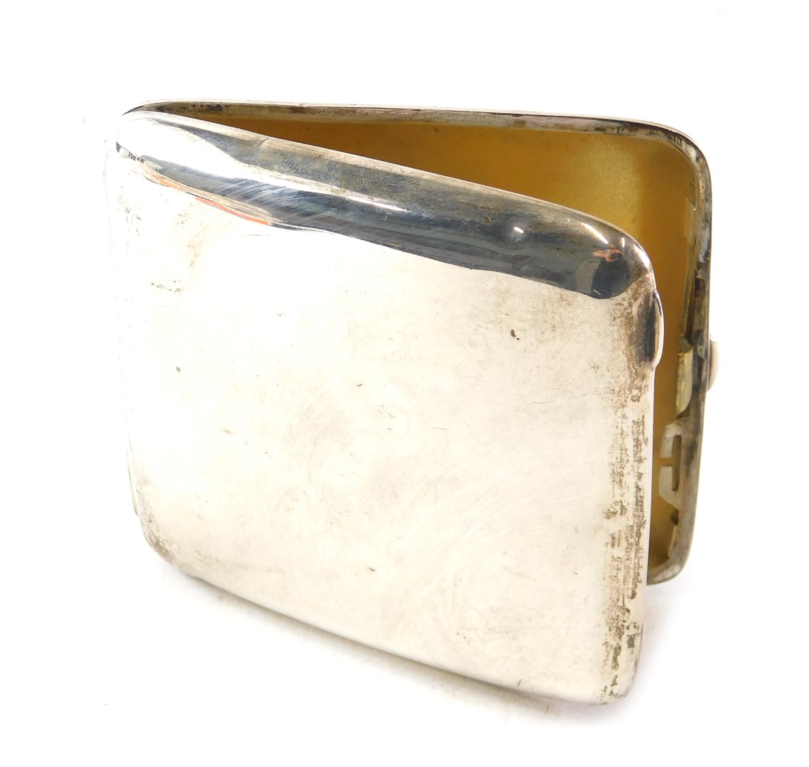 A late Edwardian silver cigarette case, of plain curved design, with silver gilt interior, Chester 1
