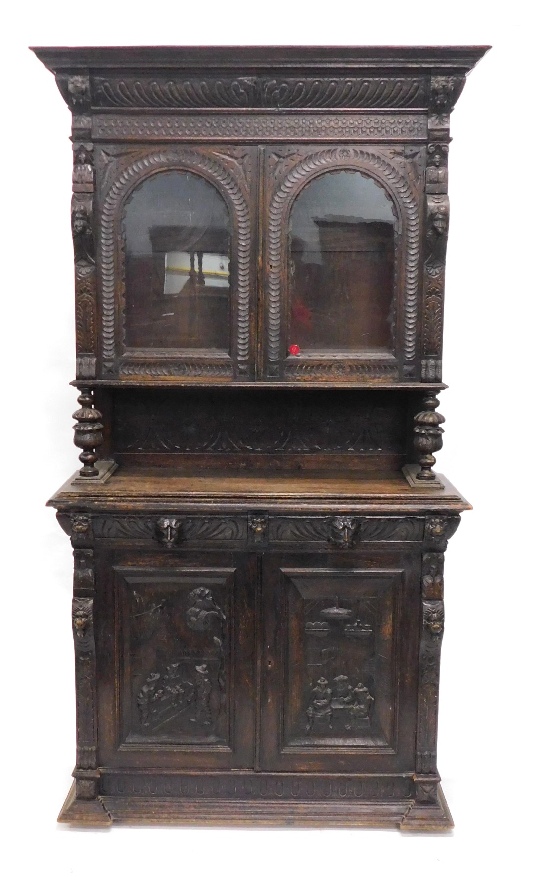 A late 19thC Flemish style ebonised oak cabinet, the top with a moulded cornice above gadrooned frie